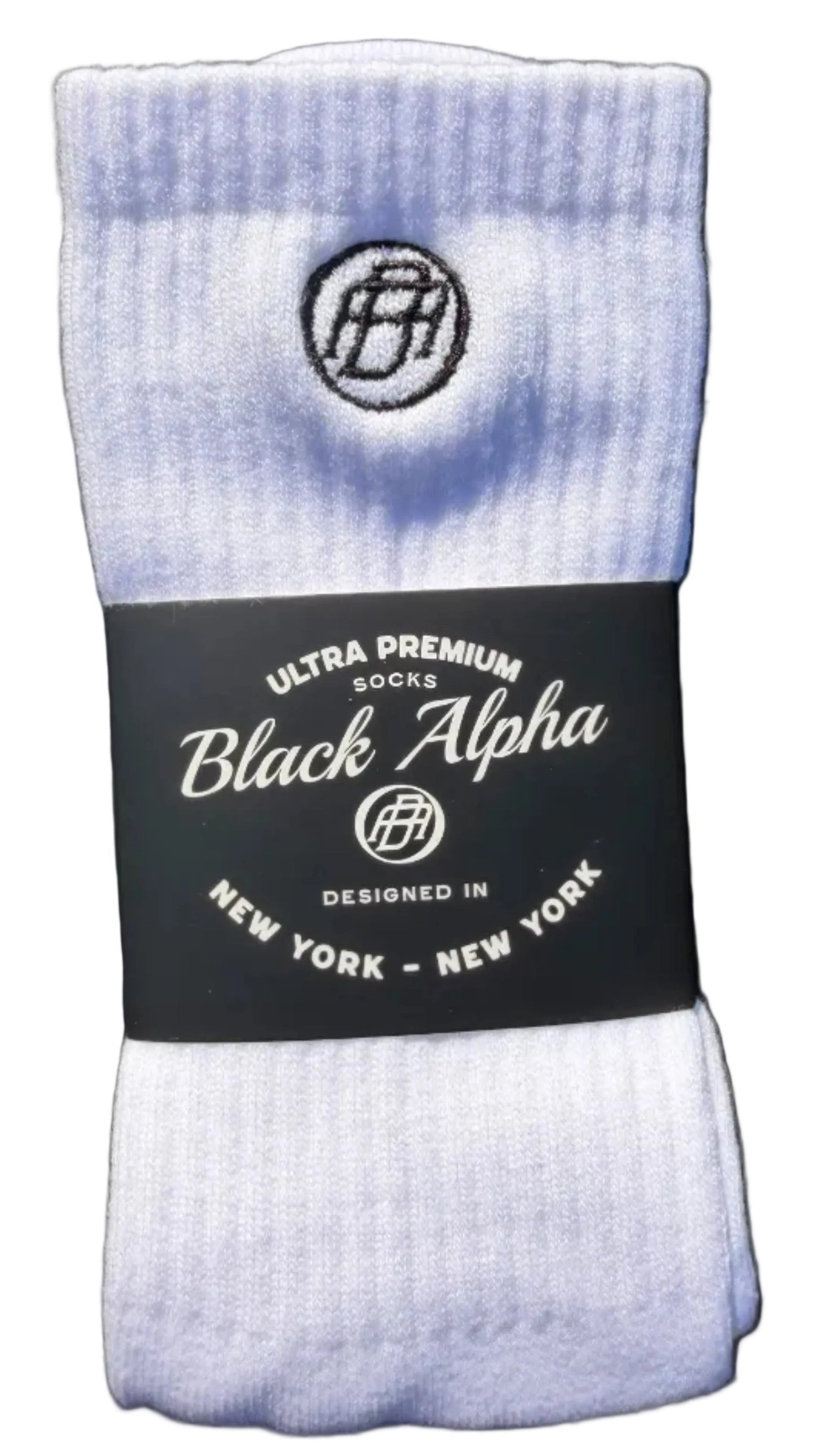 White socks with a Black Alpha label on a dark background