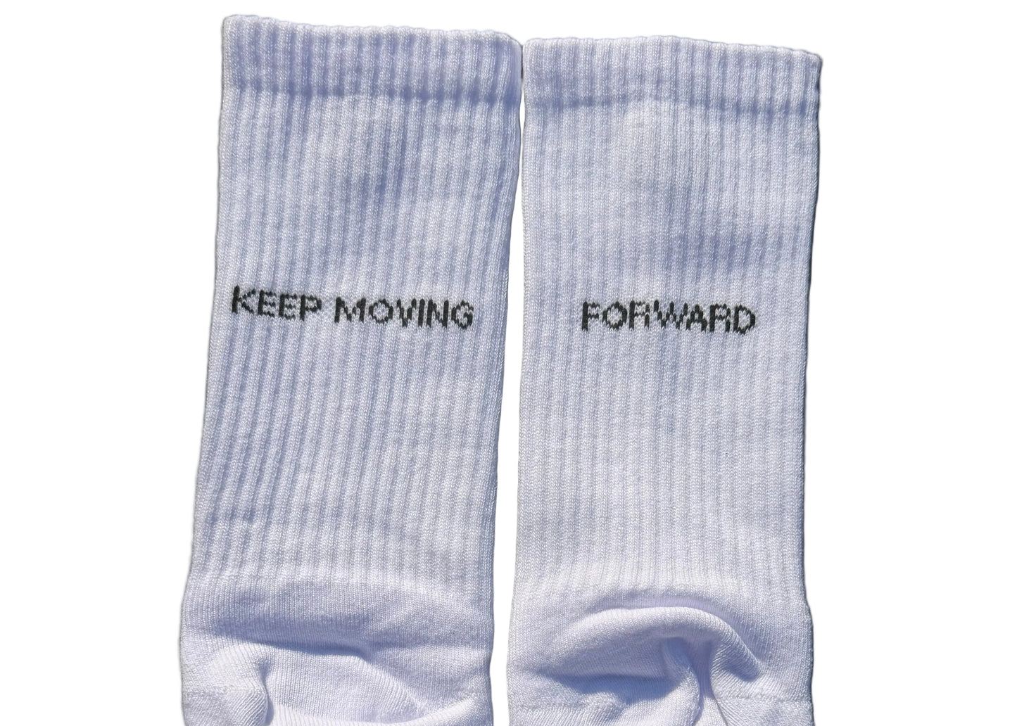 Pair of light white socks with text on a black background