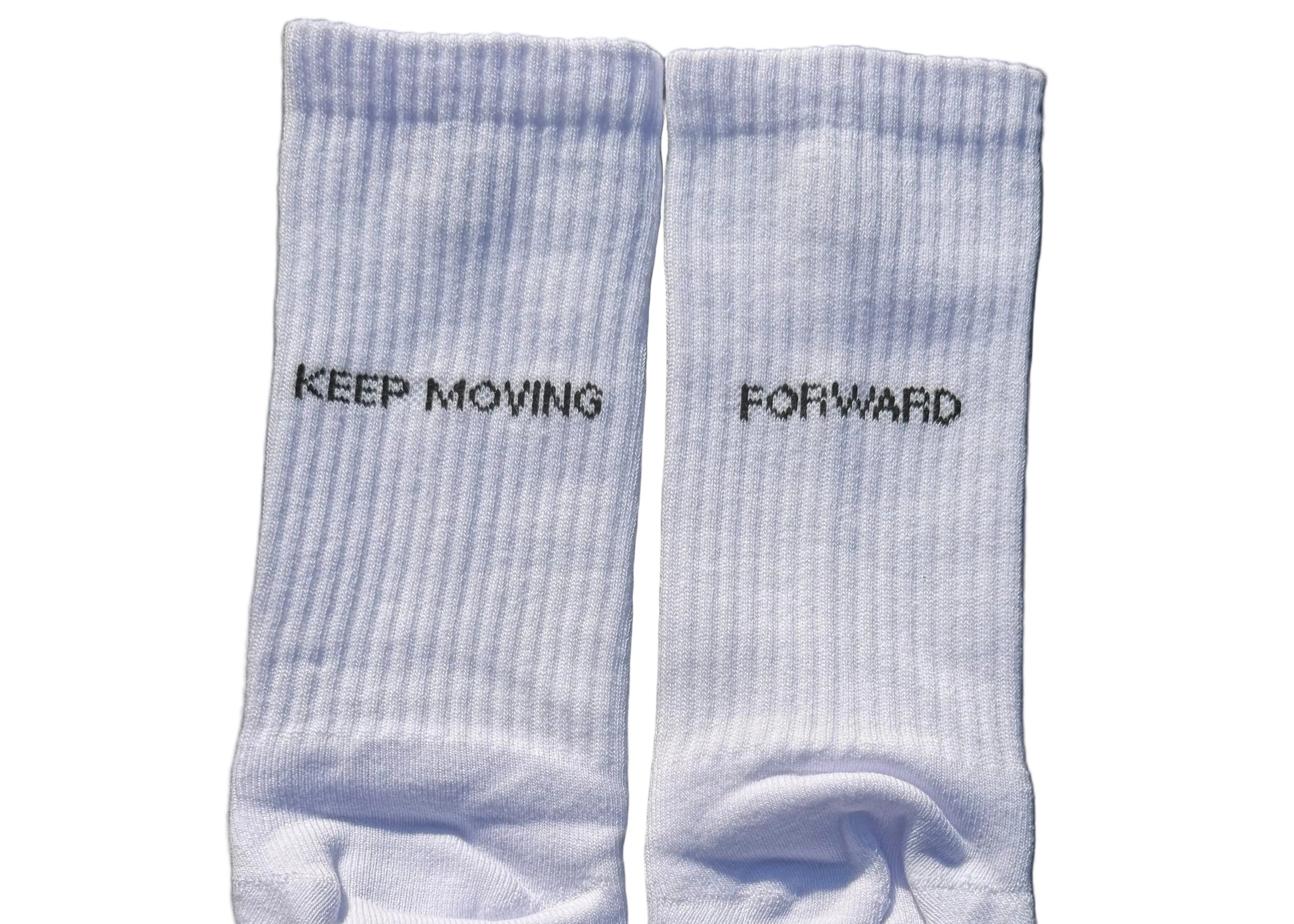 Pair of light white socks with text on a black background